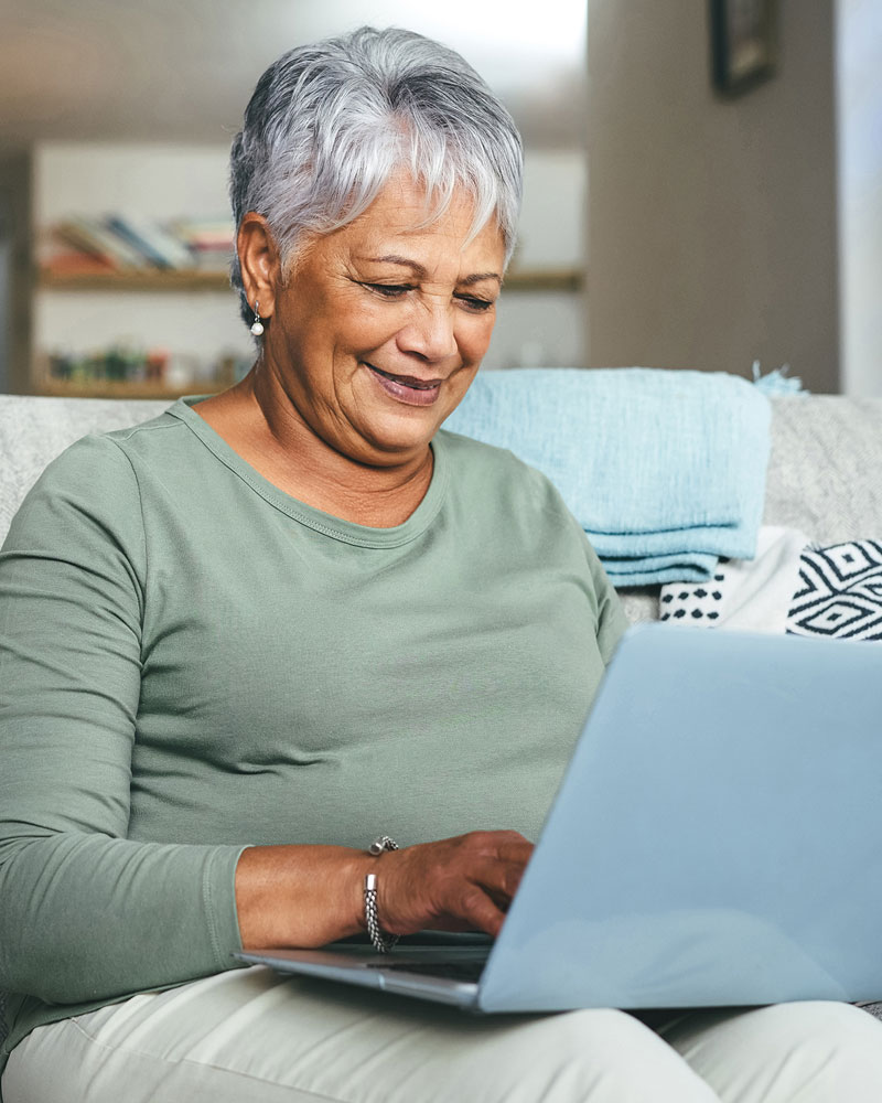 Contact Us Today! Photo of an aging woman using a laptop.